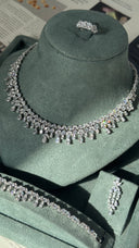 Elegant bridal jewelry set with teardrop zirconia necklace and matching bracelet on display