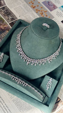 Bridal jewelry set with necklace earrings and ring styled for wedding display