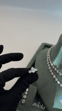 Close view of an adjustable rhodium plated bridal ring with pear cut and princess cut zircon stones