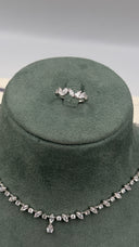 Adjustable zircon ring with matching delicate necklace close-up
