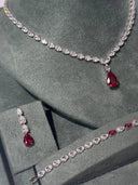 Elegant bridal ring with red teardrop stone and zircon