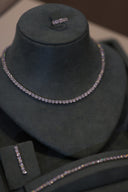 Close-up of bridal tennis necklace with round zircon stones evenly set in a single line