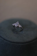 Bridal ring with teardrop center stone and side zircon details shown in close-up