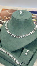 Full bridal jewelry set with pearl necklace earrings bracelet and ring displayed in box