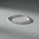 Close-up of silver tennis bracelet featuring round cut AAAAA cubic zirconia stones with diamond-like sparkle
