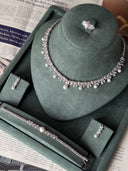Close-up of bridal necklace with small pearls and zircon leaf design on display stand