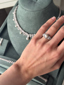 Bridal pearl ring worn on hand showing central pearl and delicate zircon leaves