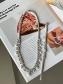 Bridal wedding jewelry set with pearl necklace, matching bracelet, pearl drop earrings and pearl ring displayed on stand
