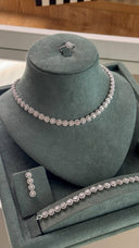 Close-up of bridal necklace with round cluster zircon stones forming floral-like shapes