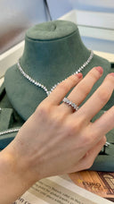 Close-up of bridal zircon ring worn on hand showing marquise and round stones