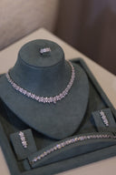 Complete bridal jewelry set including floral necklace, bracelet, earrings and ring arranged on display