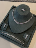 Luxury bridal jewelry set with floral zircon necklace, matching bracelet, leaf earrings and adjustable ring displayed on stand