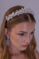 Pearl floral bridal tiara worn by a bride, featuring white pearls and clear beaded flowers in an elegant wedding crown design.