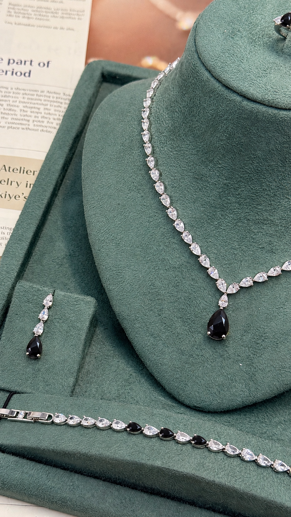 Clear pear cut Riviera bridal necklace with a black teardrop pendant and matching tennis bracelet