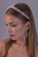 Pearl bridal tiara worn by a bride, featuring white pearls and clear silver leaves in a delicate wedding crown design.