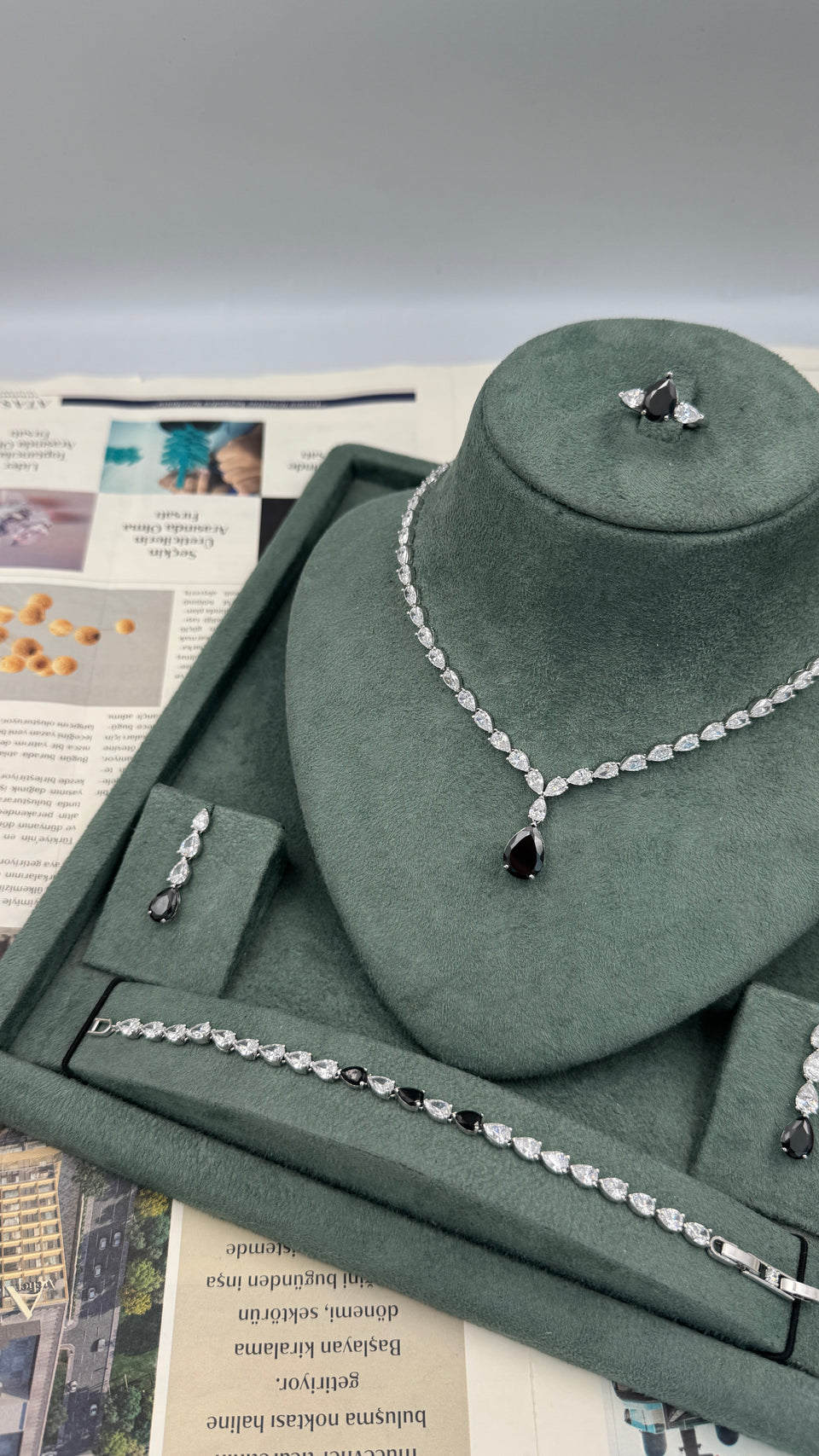 Complete rhodium plated bridal jewelry set with black teardrop tennis necklace earrings bracelet and adjustable ring