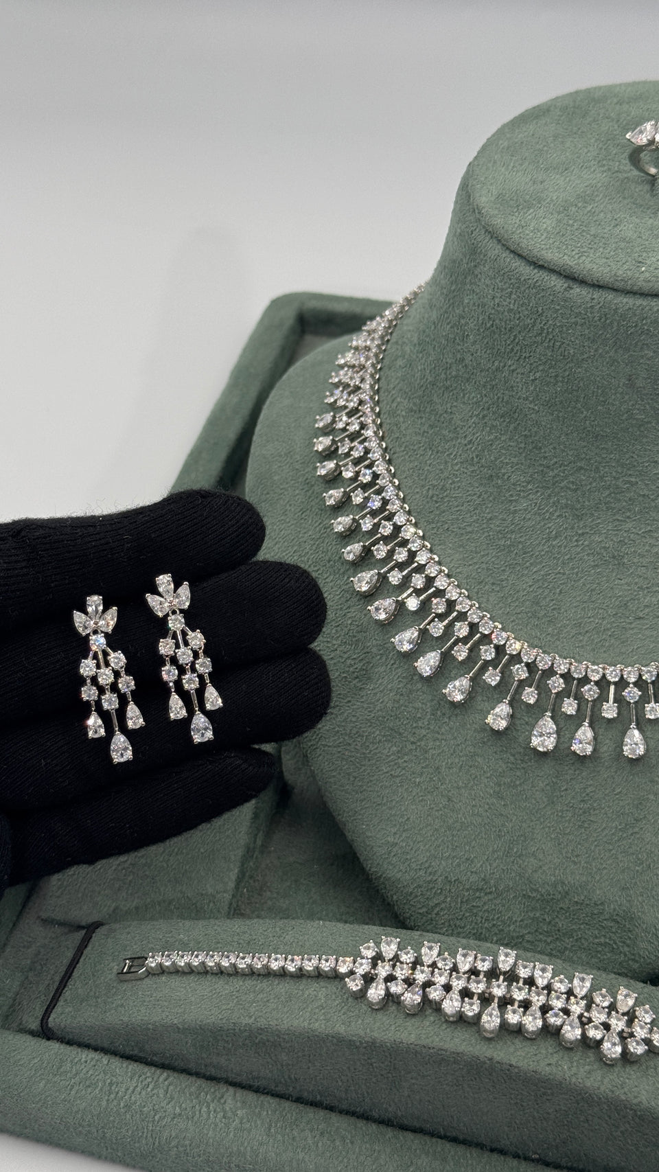 Pair of clear zircon chandelier bridal earrings with floral pear cut tops and three graduated drops