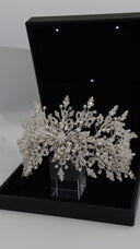 Close-up detail of crystal flower center on bridal hair vine with pearl accents