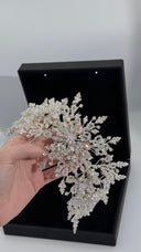 Bridal hair vine size reference held in hand showing statement floral crystal structure
