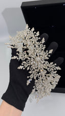 Bridal hair vine shown on gloved hand highlighting sparkle crystals and pearl accents