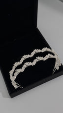 Angled view of crystal leaf bridal headband in silver color