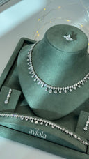 Clear pear cut bridal jewelry set with a teardrop fringe necklace matching earring and tennis bracelet