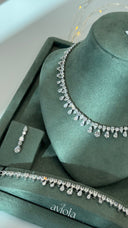 Clear pear cut bridal jewelry set with a teardrop fringe necklace matching earring and tennis bracelet