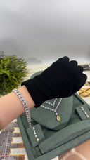 Double-row pear-cut zircon bridal bracelet worn on the wrist with the matching yellow wedding jewelry set behind