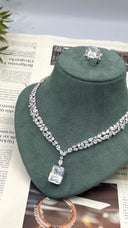 Clear zircon bridal necklace with marquise leaf stones and a large rectangular emerald-cut pendant, displayed beneath the matching statement ring