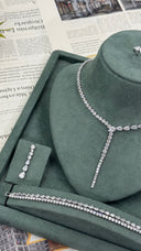 Bridal jewelry display featuring a zircon Y necklace, one drop earring and two matching tennis bracelets