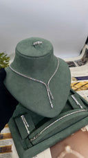 Close view of a round zircon lariat bridal necklace with two marquise-tipped drops and matching jewelry pieces