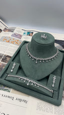 Complete wedding jewelry display featuring a clear zircon leaf fringe necklace, matching long earrings, bracelet and marquise ring