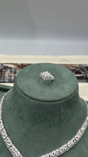Close-up of an adjustable marquise cluster bridal ring displayed above the matching clear zircon leaf necklace