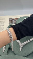 Graduated marquise leaf zircon bridal bracelet worn on the wrist with the matching V-shaped wedding necklace behind
