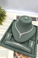 Complete clear zircon bridal wedding jewelry set displayed with a marquise leaf V necklace, floral earrings, bracelet and adjustable ring