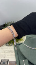 Two clear zircon bridal bracelets, one pear-cut and one round tennis design, worn together for an elegant wedding look