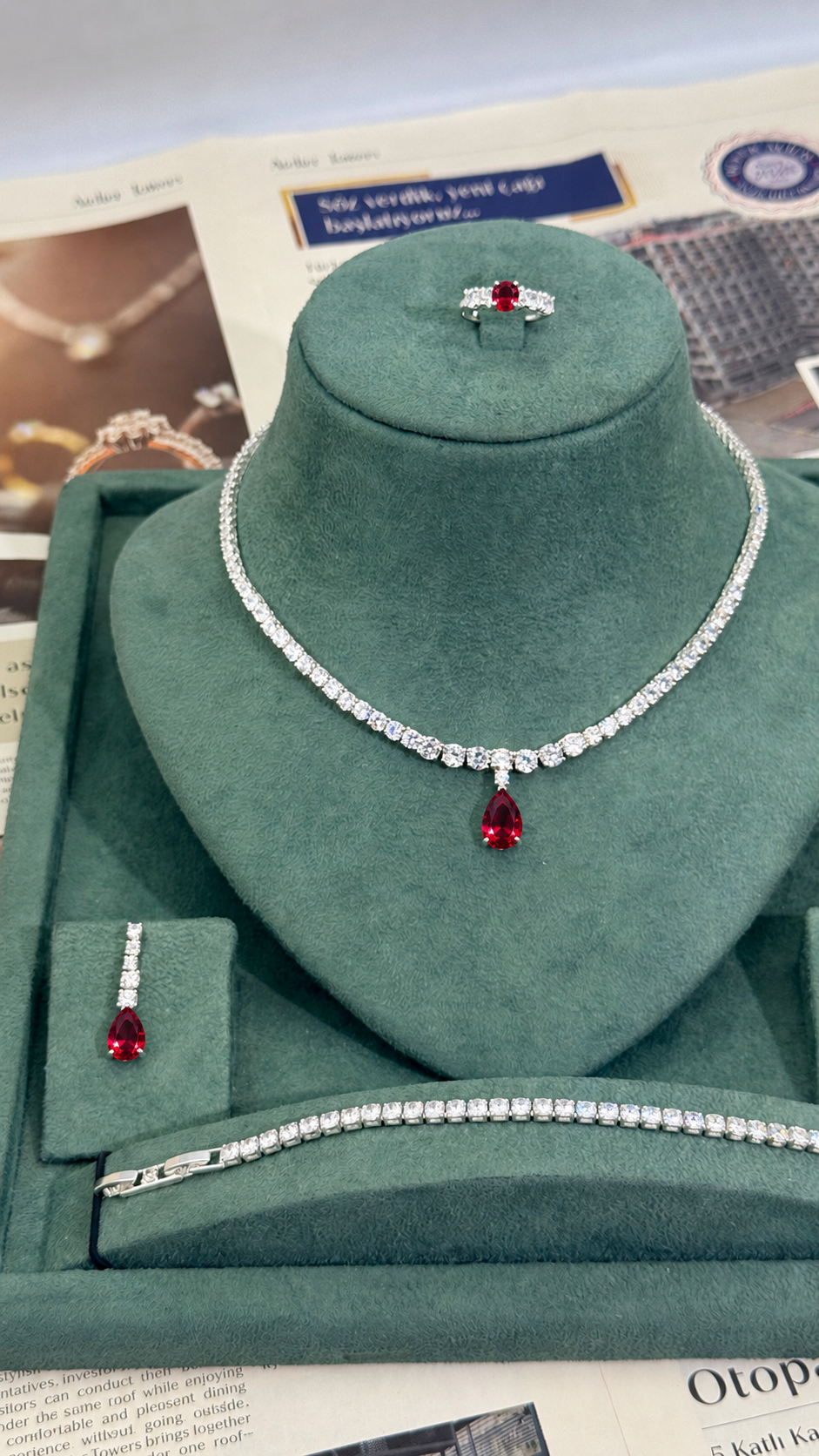 Complete four piece bridal jewelry set with red teardrop tennis necklace matching earrings tennis bracelet and adjustable ring