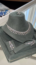 Complete bridal wedding jewelry set with a clear zircon teardrop fringe necklace, drop earrings, cuff bracelet and ring