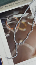 Close-up of a clear zircon Y lariat bridal necklace with round and pear-cut stones in an asymmetrical wedding design