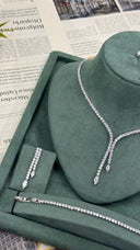 Bridal wedding jewelry set displayed with a double-drop zircon Y necklace, matching earrings and tennis bracelet