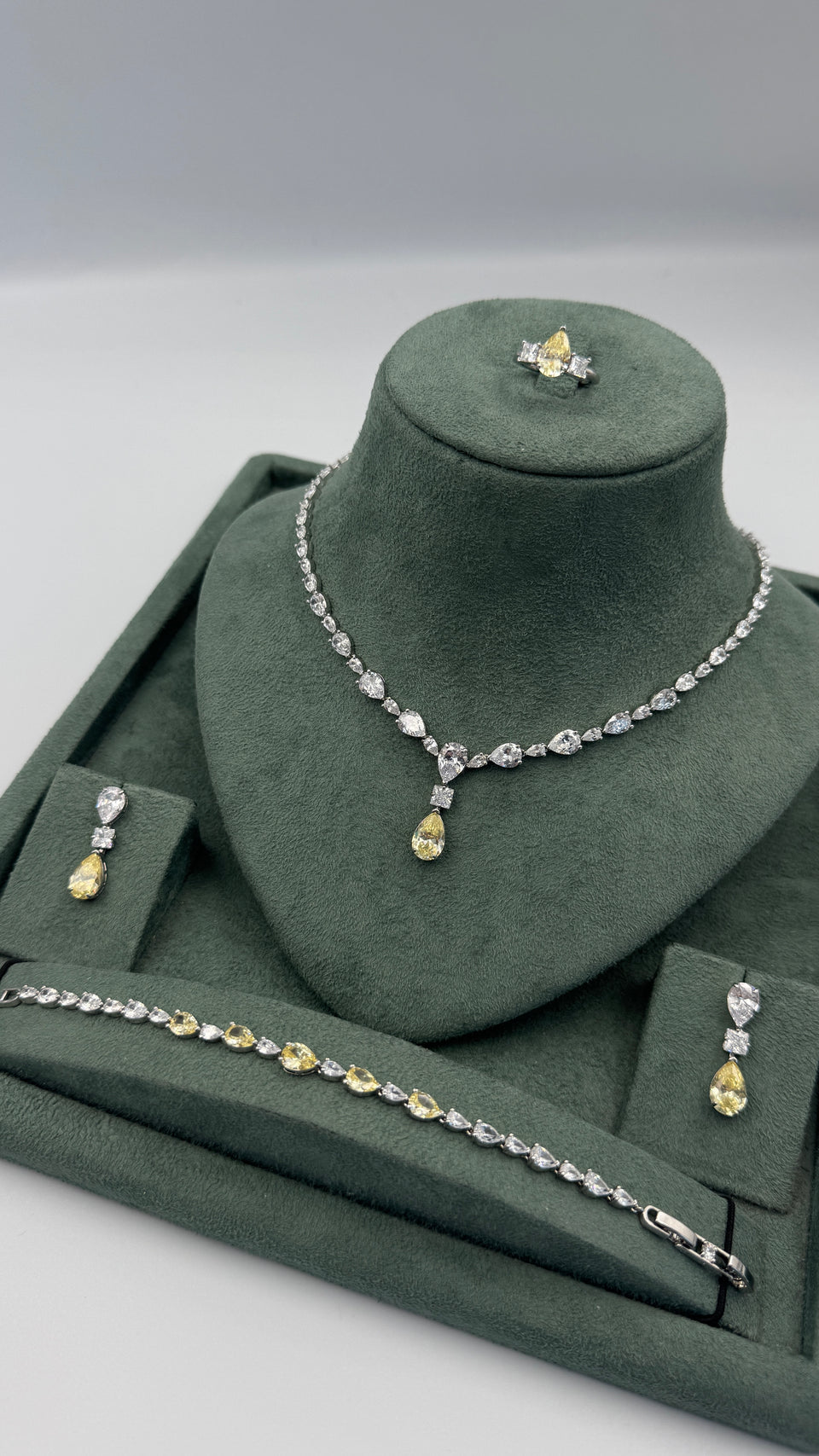 Complete bridal jewelry set with a yellow pear-cut tennis necklace, teardrop earrings, bracelet and adjustable ring