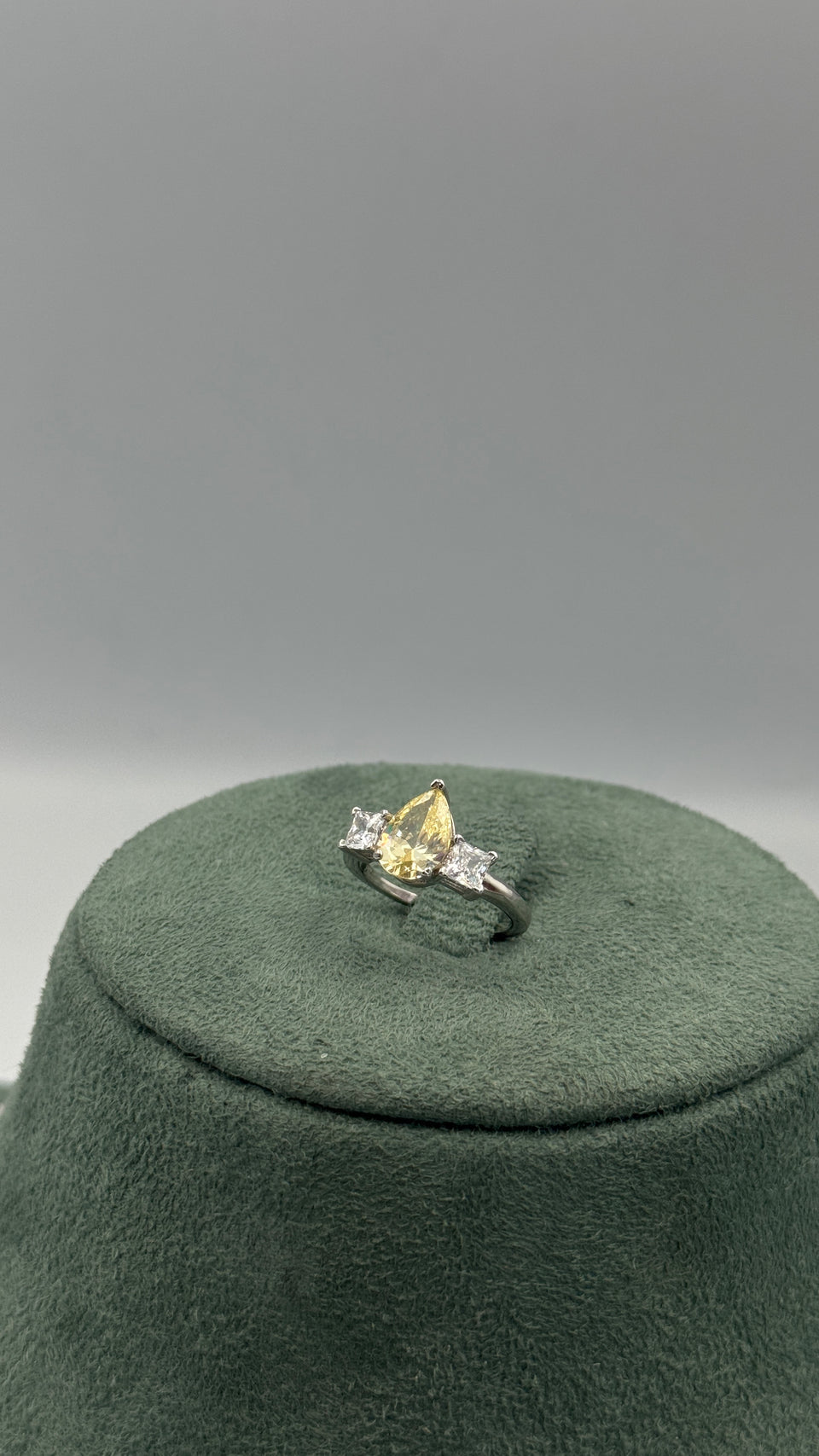 Adjustable bridal ring with a golden-yellow pear-cut zircon center and two clear princess-cut side stones