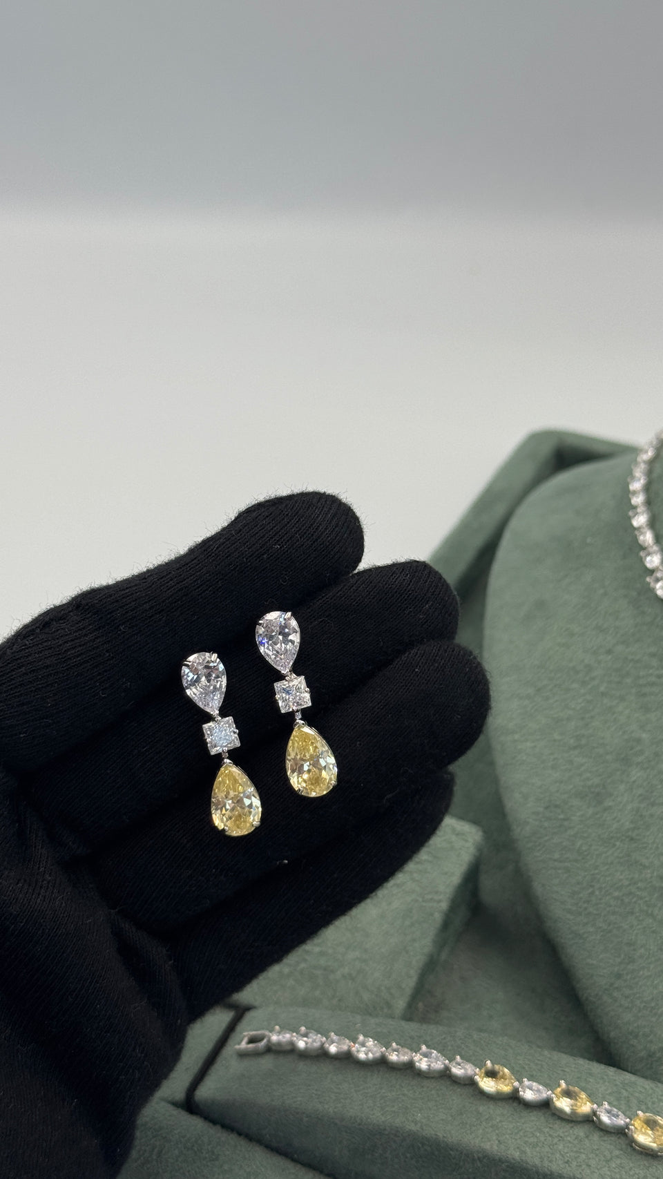 Pair of bridal drop earrings with clear pear-cut tops, square zircon centers and yellow teardrop stones