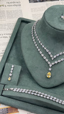 Bridal wedding jewelry set with a layered pear-cut zircon necklace, yellow teardrop pendant, bracelet and drop earring