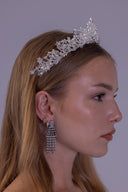 Angled view of a star and moon wedding tiara featuring luminous pearls, clear faceted beads and delicate silver celestial branches.