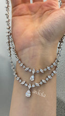 Close view of a double layer marquise tennis necklace with two clear pear cut zircon pendants