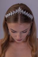 Botanical zircon wedding tiara shown at an angle, with layered silver leaves and a softly graduated crown silhouette for brides.