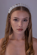 Front view of a silver-plated bridal tiara with AAAA zircon leaf clusters, white pearl accents and a softly graduated centre.