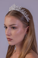 Angled view of a romantic wedding tiara with airy zircon branches rising toward the centre