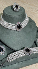 Close-up bridal choker with layered pearls and black zircon centerpiece